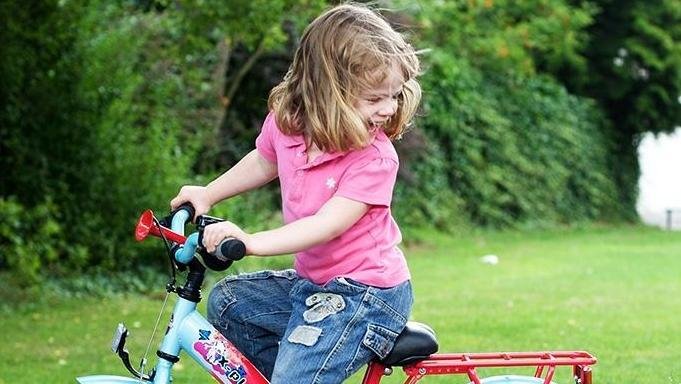 Child riding a bicycle outdoors