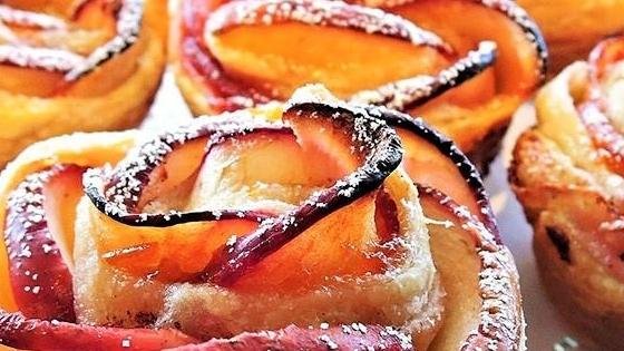 Fruit-topped pastries with a dusting of sugar